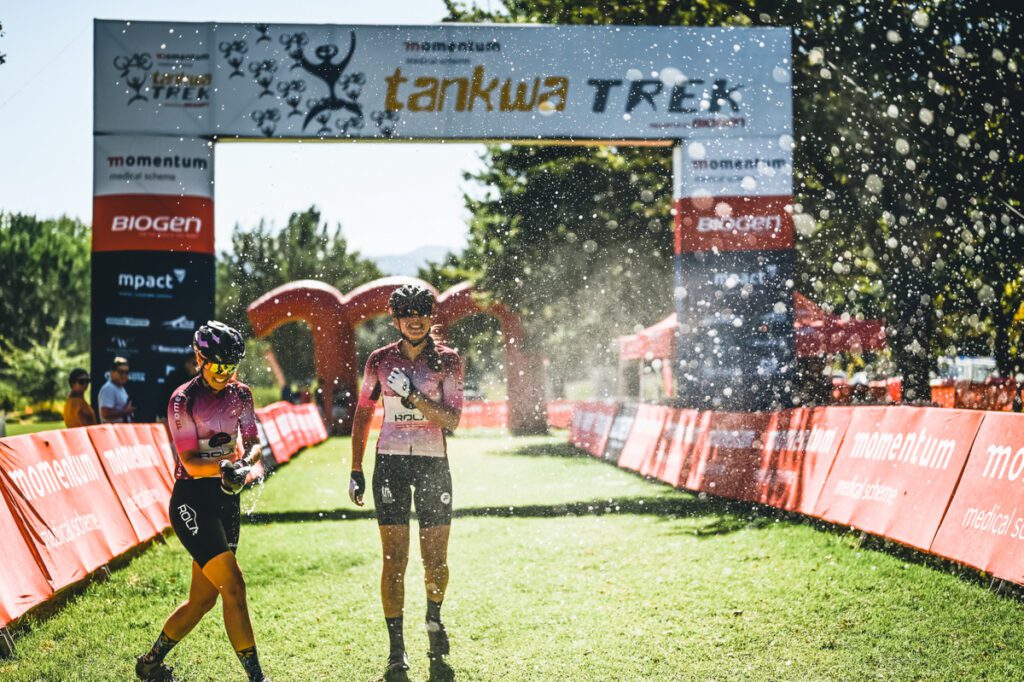 Mariske Strauss (Left) And Candice Lill (Right) Thoroughly Deserved Their Cap Classic Shower For Their Dominant Performance Over The Preceding Four Stages At Tankwa Trek. Photo By Sage Lee Voges / Www.zcmc.co.za.